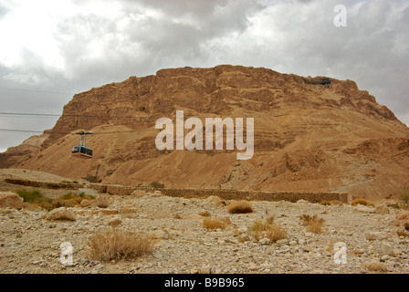 Aerial tramway to remains of King Herod's ancient Jewish palace fortress atop big mesa in Masada National Park Stock Photo