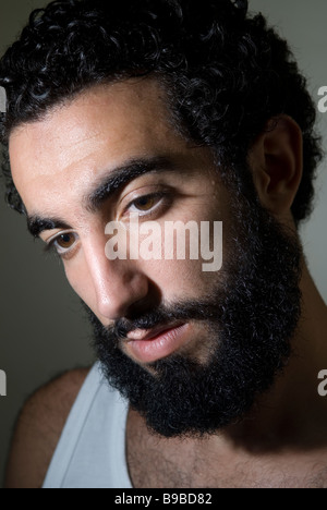 Close up portrait of a young Middle Eastern man with long beard Stock Photo