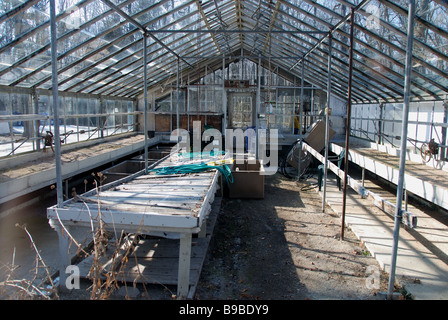 The inside view of an old and decrepit empty greenhouse in need of repair. Stock Photo