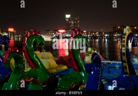 Baltimore paddle boats with city lights in the background. Stock Photo