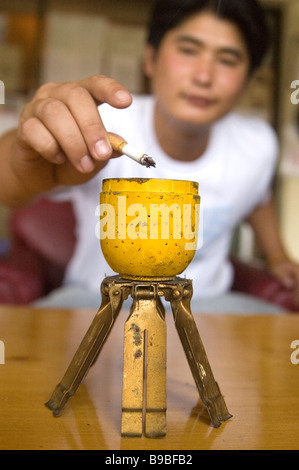 A BLU 3 cluster bomb pine apple bomb converted to an ash tray left over from the US and Vietnamese secret war in Phonsavan Laos Stock Photo