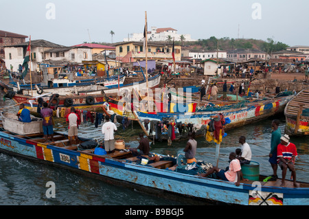 West Africa Ghana Coast Elmina fishing dugouts loaded with fishing nets at harbour with fort st jago in bkgd Stock Photo