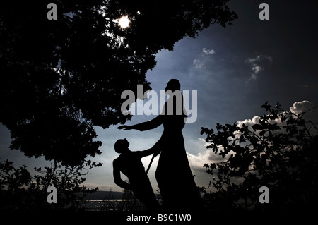 Statue depicting Jesus Christ and St Peter beside the Church of the Primacy of Tabgha at the western coast of the Sea of Galilee in northern Israel Stock Photo