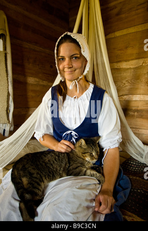 American frontier woman settler in bedroom with cat 1830s Jones Stock Farm George Ranch Historical Park Houston texas tx Stock Photo