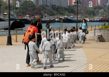 nursery school walking in street, Aberdeen, Hong Kong island, China Stock Photo