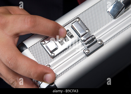 Business man unlocking a combination lock a of a briefcase Stock Photo