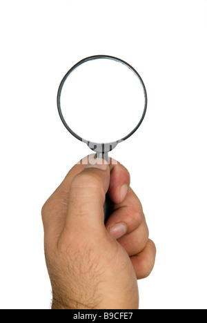 Man's hand holding a magnifying glass cutout against a white background Stock Photo