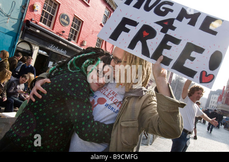 A young couple give each other a spontanious hug in central Brighton East Sussex UK just for the fun of it. Stock Photo