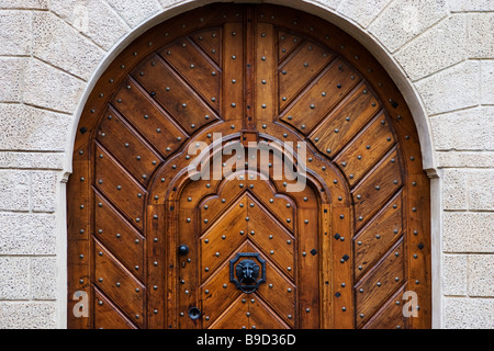 Big arched medieval house door with wicket gate inside it in Prague, Czech Republic. Stock Photo