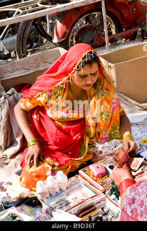 An Indian beauty sells bangles and makeup products in the vibrant Bikaner market, Rajasthan, India. Stock Photo