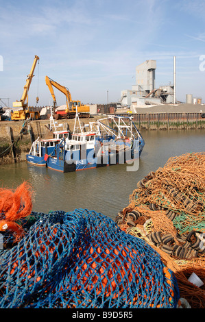 whitstable harbor harbour with fishing boats and fishing nets in the foreground Stock Photo