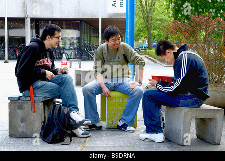 Asian students in front of the University of Braunschweig, Germany Stock Photo