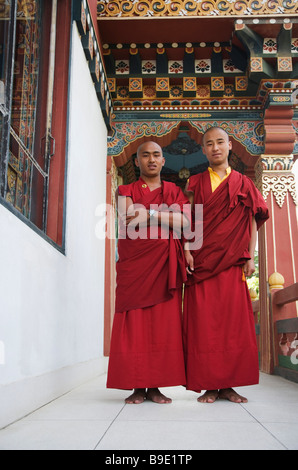 Two monks standing in the temple, Bhutan Temple, Bodhgaya, Gaya, Bihar, India Stock Photo