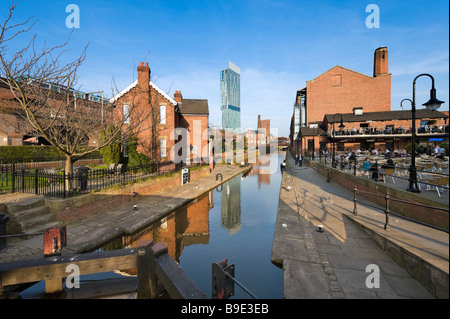 Cafe and bar in the redeveloped canalside area of Castlefield with the Beameth Tower in the distance, Manchester, England Stock Photo