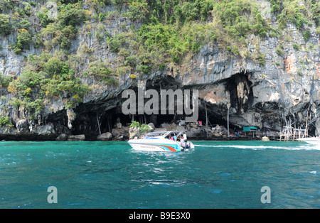 Tourist boats in Viking cave on the island of Phi Phi Ley off the coast of Phuket Thailand Stock Photo