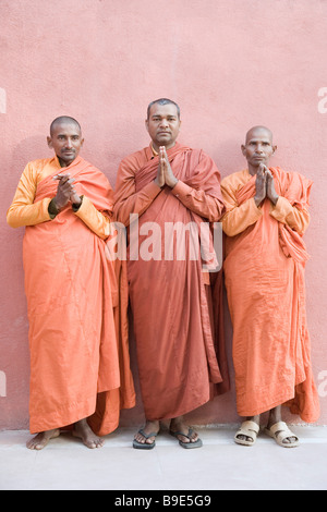 Three monks praying, Bodhgaya, Gaya, Bihar, India Stock Photo