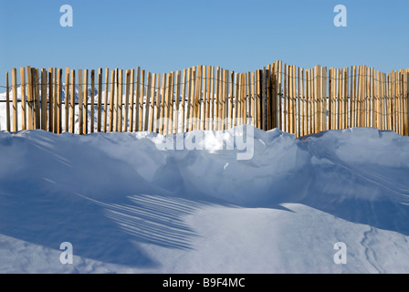 Fencing along  ridge above the ski resort of Val Thorens traps blown snow. Stock Photo