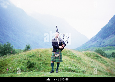 Piper playing bagpipes at Glencoe Highlands Scotland Stock Photo - Alamy