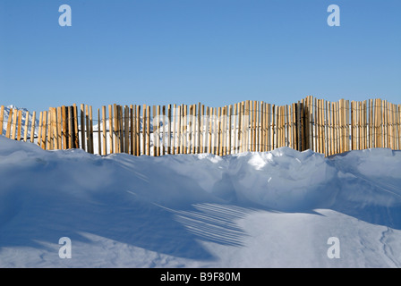 Fencing along  ridge above the ski resort of Val Torens traps blown snow. Stock Photo