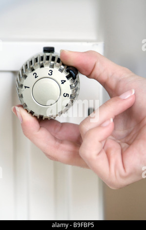 Close-up of woman's hand adjusting knob Stock Photo