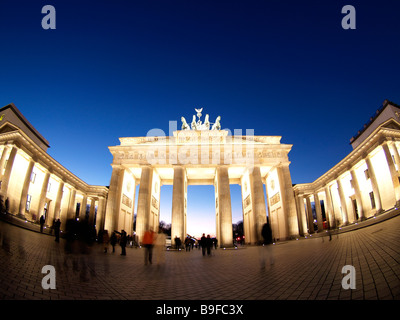 Tourists at monument lit up during dusk Brandenburg Gate Berlin Germany Stock Photo