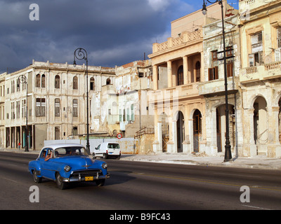 Vintage car traveling on city road Stock Photo