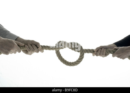 Close-up of two men pulling rope Stock Photo