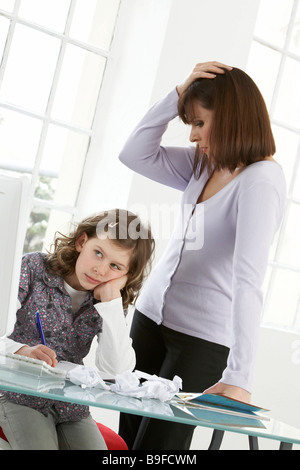 Woman and her daughter looking stressed Stock Photo