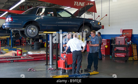 Motor car on hydraulic lift repair workshop Springfield Missouri USA Stock Photo