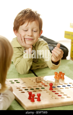 girl boy ludo plays detail series people children board-game game dice wooden dice cheerfully fun enjoyments together siblings Stock Photo