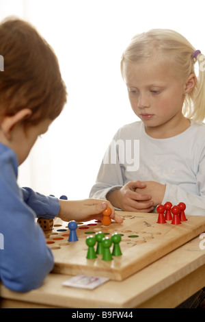 girl boy ludo plays detail series people children board-game game dice wooden dice cheerfully fun enjoyments together siblings Stock Photo