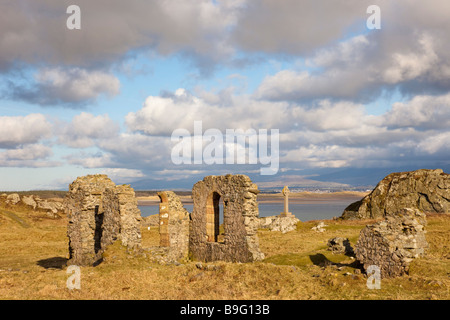 Historic 16th century ruins of St Dwynwen's church with Celtic cross on Ynys Llanddwyn Island in AONB. Anglesey North Wales UK Stock Photo