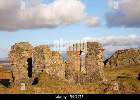 Anglesey North Wales UK Historic 16th century ruins of St Dwynwen's church with Celtic cross on Ynys Llanddwyn Island in AONB Stock Photo
