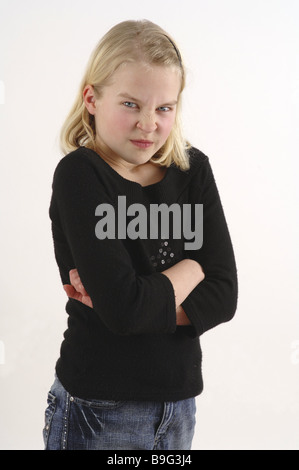 girl blond poor crosses angrily detail series people child jeans sweaters facial expression petulant sullen unsatisfied Stock Photo