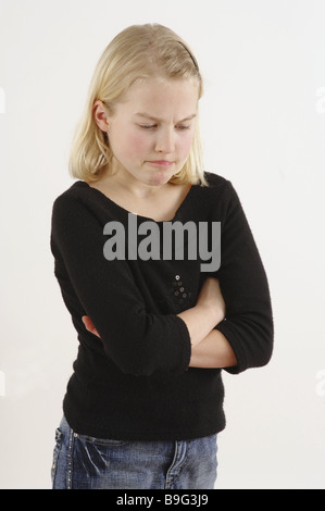 girl blond poor crosses angrily detail series people child jeans sweaters facial expression petulant sullen unsatisfied Stock Photo