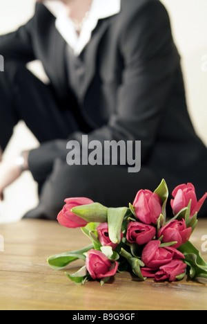 Sits man  suit  flower-bouquet  waits  broached  series  people  rendezvous  falling in love  flowers  tulips  tulip-bouquet Stock Photo