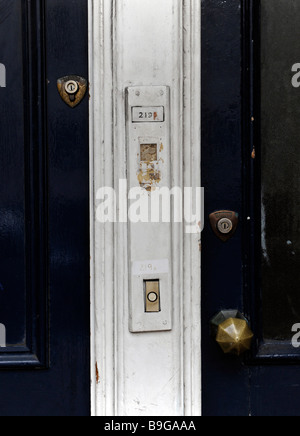 Two front doors to city flats, side by side with locks and door bells, buzzers Stock Photo