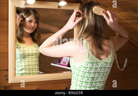 teenagers girl comb gaze mirrors reflection semi-portrait series people youth teenagers 14 years blond long-haired hair hairdo Stock Photo