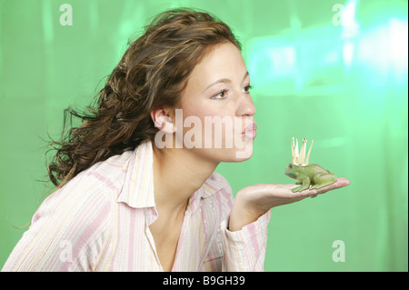 Woman young palp plastic-frog crown kisses side-portrait series people girl teenagers teenagers 18-20 years hand frog frog-king Stock Photo