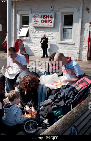 family eating fish and chips at the seaside Stock Photo