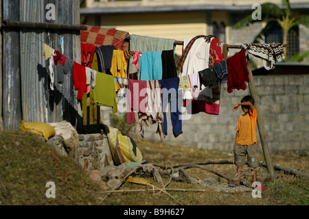 A boy stands next to a clothesline near his home in Pokhara, Nepal. Stock Photo