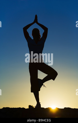 Silhouette woman gymnastics Yoga sunset Stock Photo - Alamy