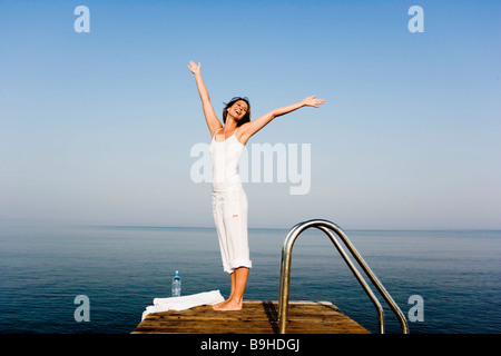 Woman having fun on a pier Stock Photo