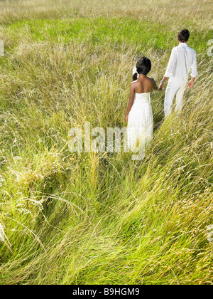 Married couple walking in a field Stock Photo