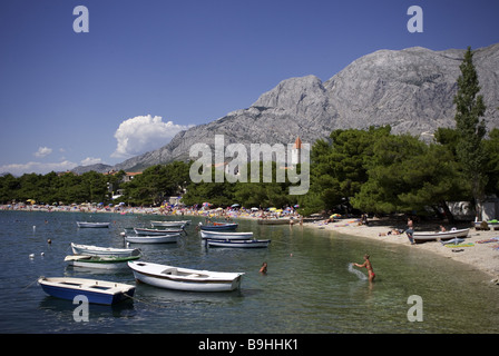 Croatia Dalpatia Makarska Riviera Promajna beach swimmers boats Europe destination coast beach Biokovo mountains place church Stock Photo