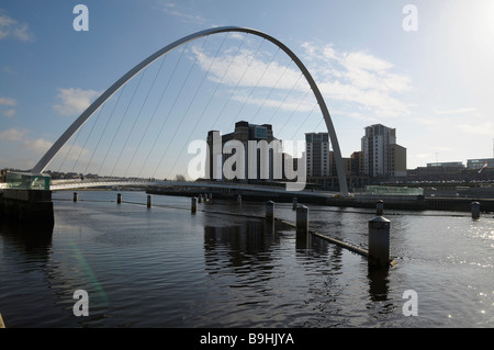 Wide view of the curve of the iconic Millennium Bridge in Newcastle-upon-Tyne, with the Baltic art gallery in the background.