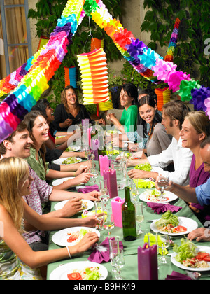 People sitting at table,  celebrating Stock Photo