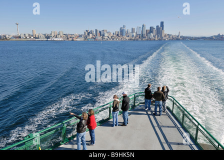 Tourists on the ferry from Seattle to Bainbridge Island, in the back the skyline of Seattle, Washington, USA Stock Photo