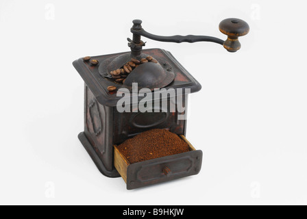 Antique metal coffee grinder with coffee beans in the grinding mill and ground coffee in the meal drawer Stock Photo