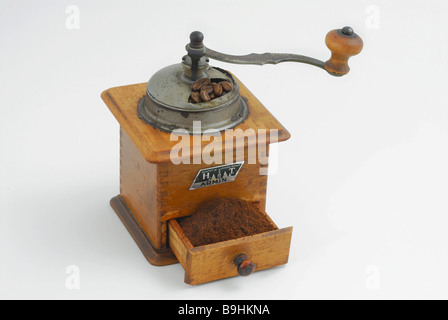 Antique wooden coffee mill with a drawer full of ground coffee Stock Photo